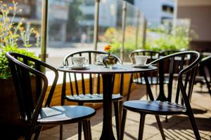 a table with chairs and cups and a vase with flowers at Quality Hotel Royal Corner in Växjö +77 photos