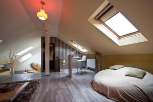a attic bedroom with a bed and a skylight at Cluj Napoca Apartments in Cluj-Napoca