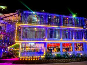 a house covered in christmas lights in front thereof at Sleeping Beauty Hotel Moutain view property in Joshīmath