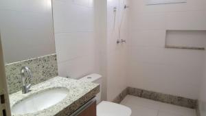 ein Bad mit einem Waschbecken, einem WC und einer Dusche in der Unterkunft Hotel Real in Montes Claros