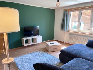 ein Wohnzimmer mit Sofa und Flachbildfernseher in der Unterkunft Ferienwohnung Alpengarten in Sedrun