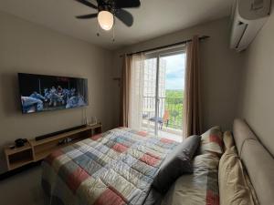 een slaapkamer met een bed, een tv en een raam bij Arastar Escape in Suba