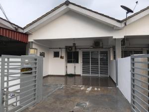 an open garage with a white house with a gate at Homestay Kuala Selangor Islamic Friendly Only in Kuala Selangor