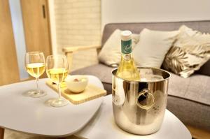 a bottle of wine sitting on a table with two glasses at Harmonia - Nest in Osaka - in Osaka