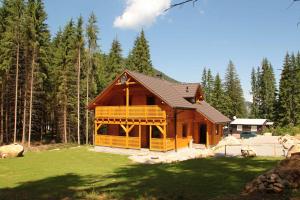 a large log cabin in the woods at Chata Iľanovka in Belá