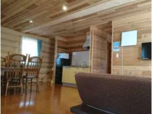 a living room with a laptop on a table at Karuizawa Sunny Village - Vacation STAY 57953v in Karuizawa