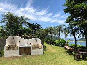 a kitchen in a backyard with a table and benches at The Little Garden - Vacation STAY 58450v in Miyazaki