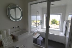 a bathroom with a sink and a tub and a mirror at MAISON DE AILE - Vacation STAY 58600v in Amami +23 photos