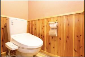 a bathroom with a white toilet and wooden walls at Kyomachiya Mitsugetsu - Vacation STAY 63459v in Kyoto