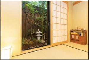 an entrance to a room with a garden outside a door at Kyomachiya Mitsugetsu - Vacation STAY 63459v in Kyoto