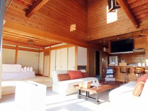 a living room with a white couch and a tv at Ocean Resort Tateyama T House - Vacation STAY 69839v in Tateyama