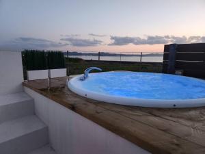 a bath tub sitting on top of a wooden deck at Ocean Resort Tateyama A House - Vacation STAY 73416v in Tateyama +5 photos