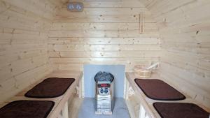 a small cabin with two beds and a stove in it at Ocean Resort Tateyama A House - Vacation STAY 73416v in Tateyama