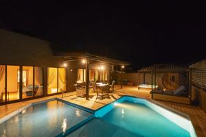 a large swimming pool in a house at night at Ocean Resort Tateyama BBQ House - Vacation STAY 73564v in Tateyama