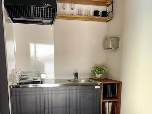 a small kitchen with a sink and a microwave at FLEXWORK tawa - Vacation STAY 75820v in Teshikaga