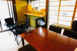 a conference room with a wooden table and chairs at Takabayashi Shoten Liquor store where you can stay - Vacation STAY 69075v in Oshima +10 photos