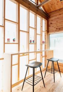 two chairs and a counter in a room with windows at Takabayashi Shoten Liquor store where you can stay - Vacation STAY 69075v in Oshima