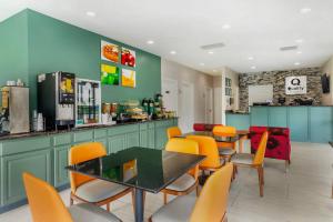 a restaurant with orange chairs and tables and a counter at Quality Inn Madison - Huntsville in Madison +21 photos