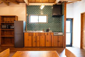 a kitchen with a sink and a refrigerator at Woodville House Kakeromajima - Vacation STAY 70527v in Setouchi