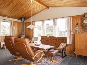 a living room with leather chairs and a table at 5 person holiday home in Ringkøbing in Søndervig +34 photos