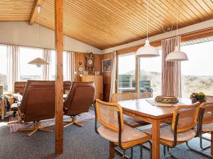 a dining room with a table and chairs at 5 person holiday home in Ringkøbing in Søndervig