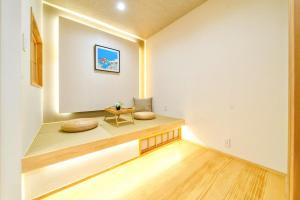 a room with a bench with pillows on it at 夏様五条丹波口 Modern Kyoto Townhouse, Whole House in Kyoto