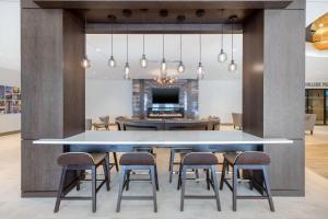 a dining room with a large table and chairs at Cambria Hotel College Park in College Park