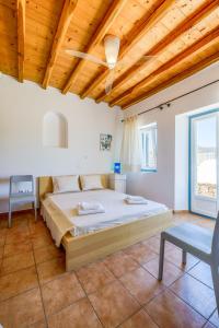 a bedroom with a bed and a wooden ceiling at Lighthouse Villa - Private Pool - Unlimited Sea View - 6 pax in Houlakia +32 photos