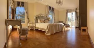 a bedroom with a bed and a table and windows at Chateau Le Marais in Wallis Island