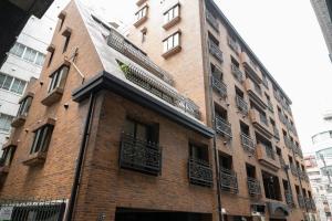 a brick building with balconies on the side of it at Sun Mall 3rd Mansion 602 - Vacation STAY 14779 in Tokyo