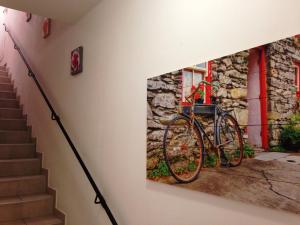 a painting of a bike hanging on a wall at Casa Barbarossa in Colico