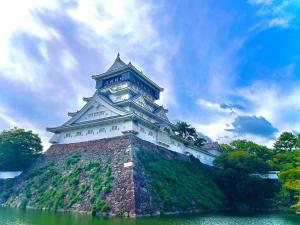 a castle on top of a hill in the water at Kitakyushu - Apartment - Vacation STAY 14808 in Kitakyushu