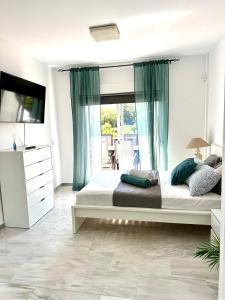 a bedroom with a large bed and a large window at Luxury villa w seaview Cabopino in Marbella