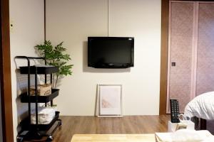 a living room with a tv hanging on the wall at Daiichi Mitsumi Corporation - Vacation STAY 15348 in Musashino