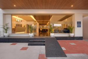 a lobby of a building with potted plants at Keys Lite by Lemon Tree Hotels, Krishna, Vijayawada in Vijayawāda +37 photos