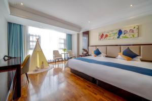 a bedroom with a large bed and a large window at Shanghai Dixuan Junlan Resort Hotel in Shanghai +77 photos