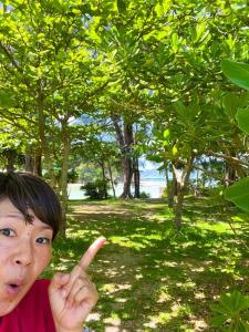 a young boy giving a peace sign with his index finger at Keisaji CAMP SITE - Vacation STAY 90073v in Ijinabaru