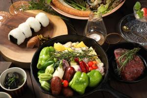 a table with a pan filled with vegetables and meat at KnotDaisen - Vacation STAY 98739v in Daisen