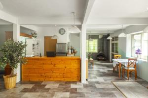 a kitchen and living room with a table and a clock at Mori no Komei campsite - Vacation STAY 04382v in Kita-karuizawa