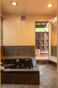 a large bath tub in a room with a window at Mori no Komei campsite - Vacation STAY 04382v in Kita-karuizawa +22 photos