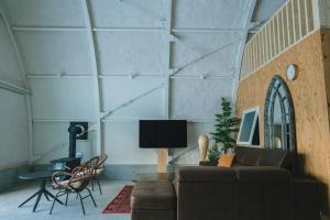 a living room with a couch and a table at FOX&CRANE Cabin - Vacation STAY 97723v in Teshikaga +8 photos