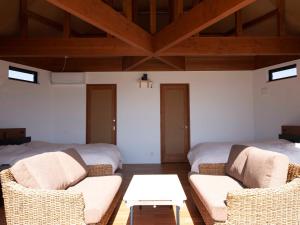a room with two beds and two chairs and a table at HV hygge setouchi - Vacation STAY 09887v in Yamaguchi