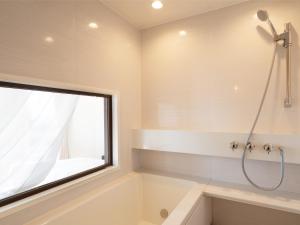 a bathroom with a tub and a window at HV hygge setouchi - Vacation STAY 09912v in Yamaguchi