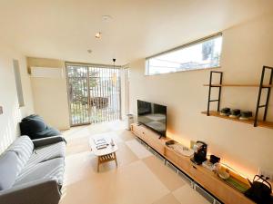a living room with a couch and a tv at ZIPANG - Vacation STAY 02088v in Matsue
