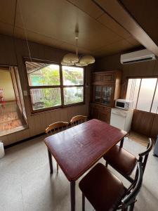a kitchen with a dining room table and chairs at Guesthouse Hikigawa - Vacation STAY 03553v in Hiki