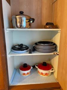two pots and pans are sitting in a cabinet at Shimanoyado Kon Bettei -En- - Vacation STAY 64087v in Oshima