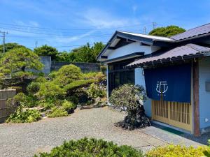 a blue house with a sign on the door at Shimanoyado Kon Bettei -En- - Vacation STAY 20794v in Oshima
