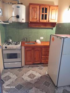 a kitchen with a stove and a refrigerator at Miniduplex tipo Cabaña in San Bernardo
