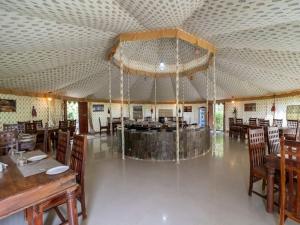 a large room with tables and chairs and a restaurant at Atithi Luxury Resort in Pushkar