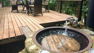 a wooden deck with a sink with a water fountain at Shimanto Yamamizuki - Vacation STAY 36946v in Shimanto